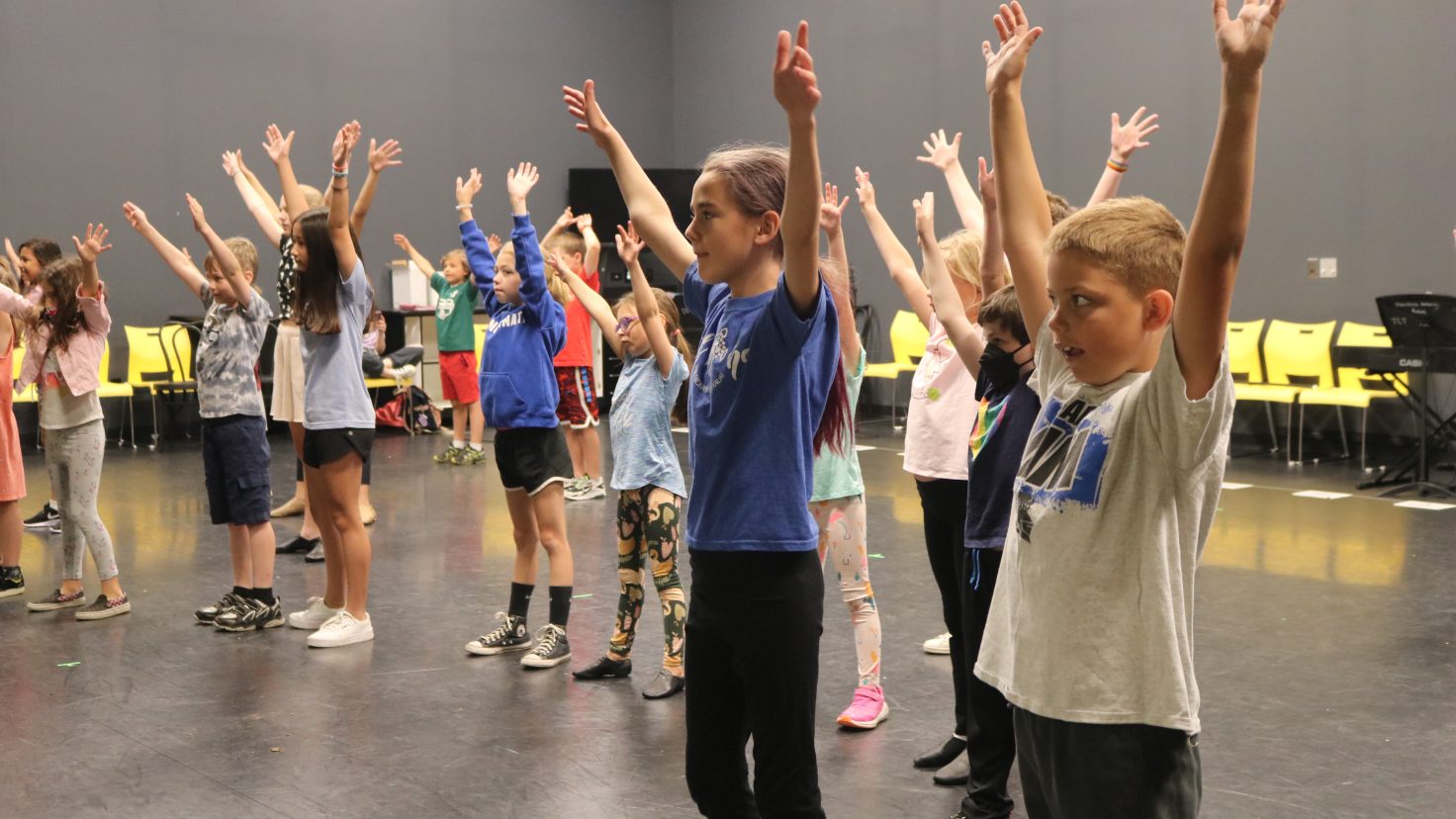 group of kids with arms up