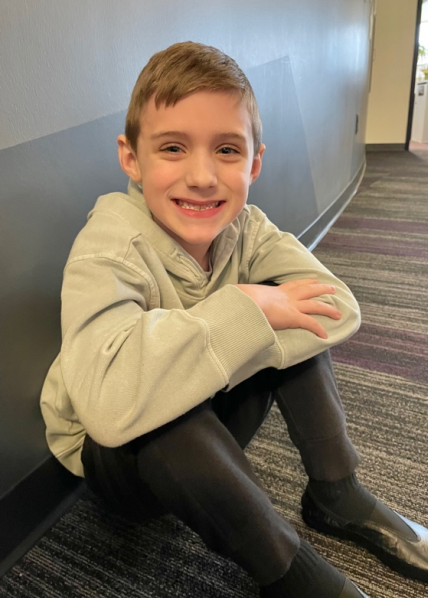 boy in gray shirt sitting down