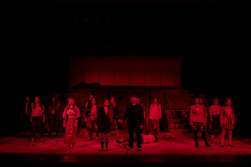 Students on stage with red lighting