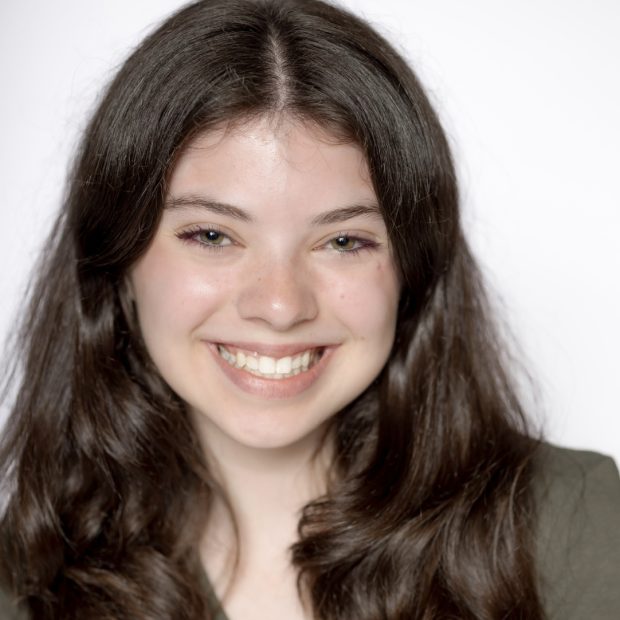 Girl with green shirt smiling