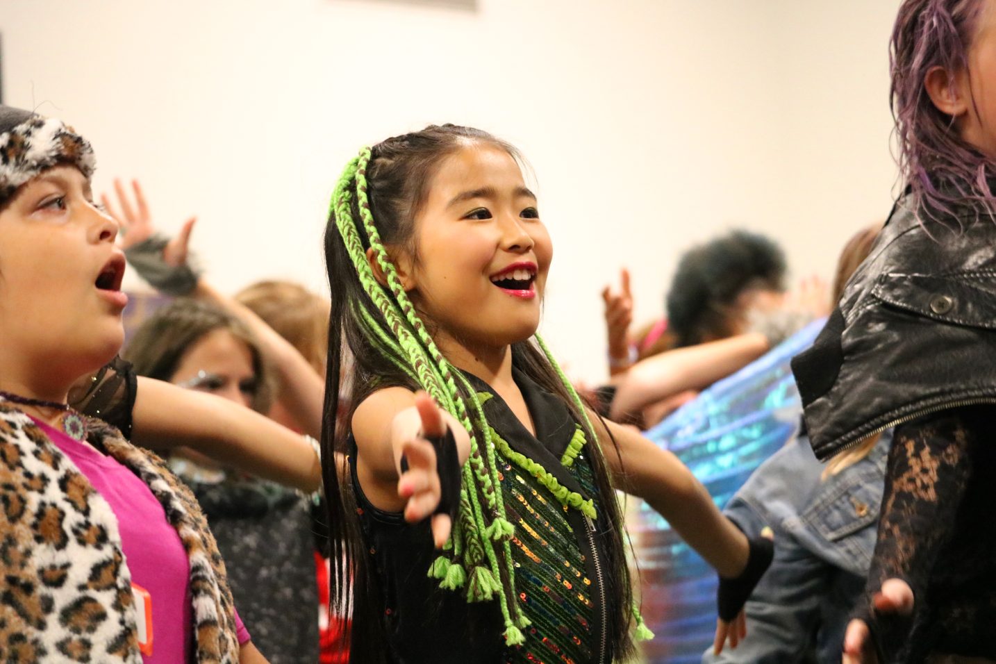 girl with green braided hair singing