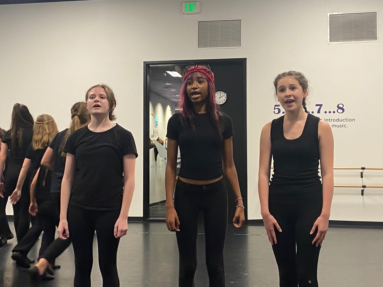 group of kids in all black dancing