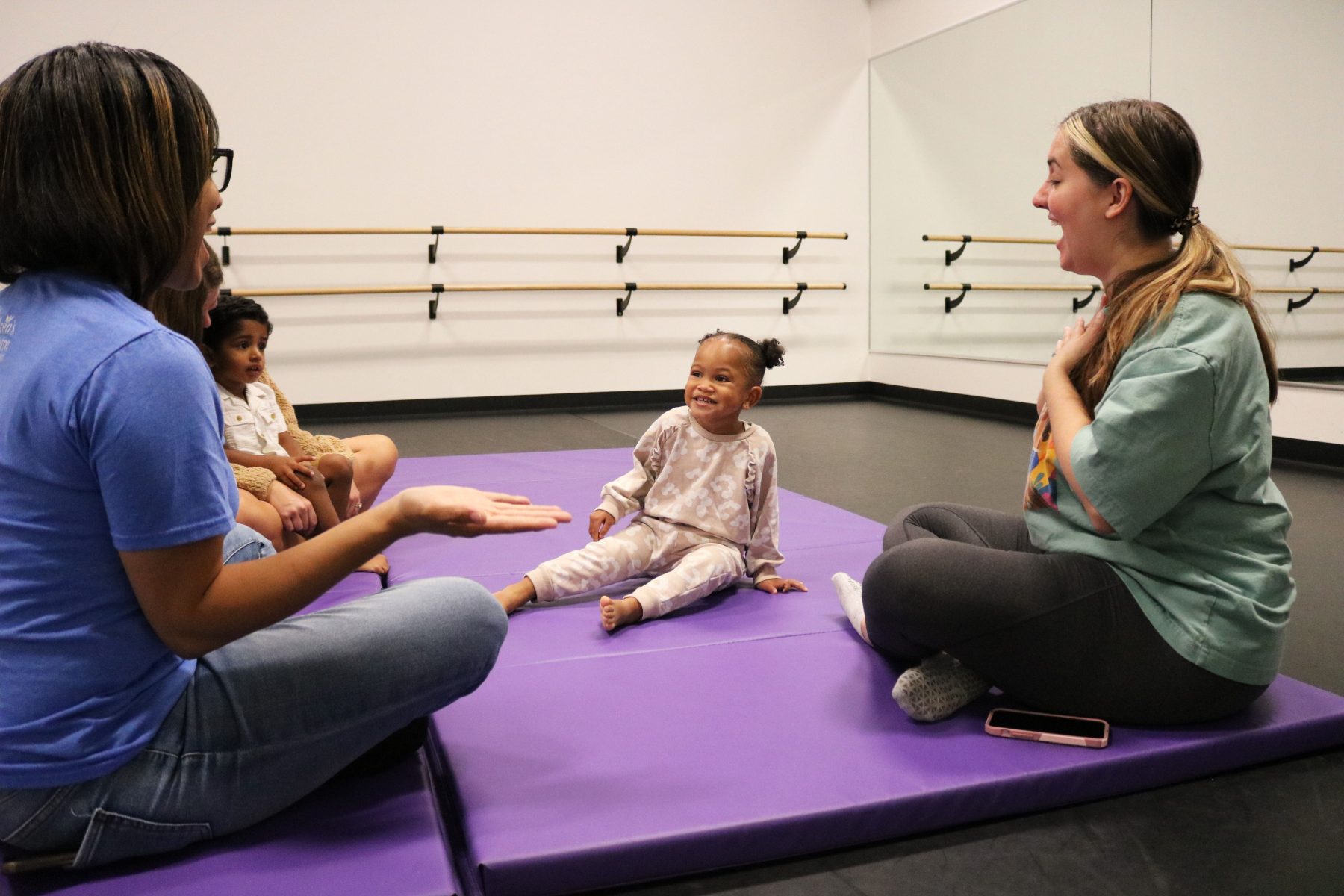 Adults and kids laughing and playing