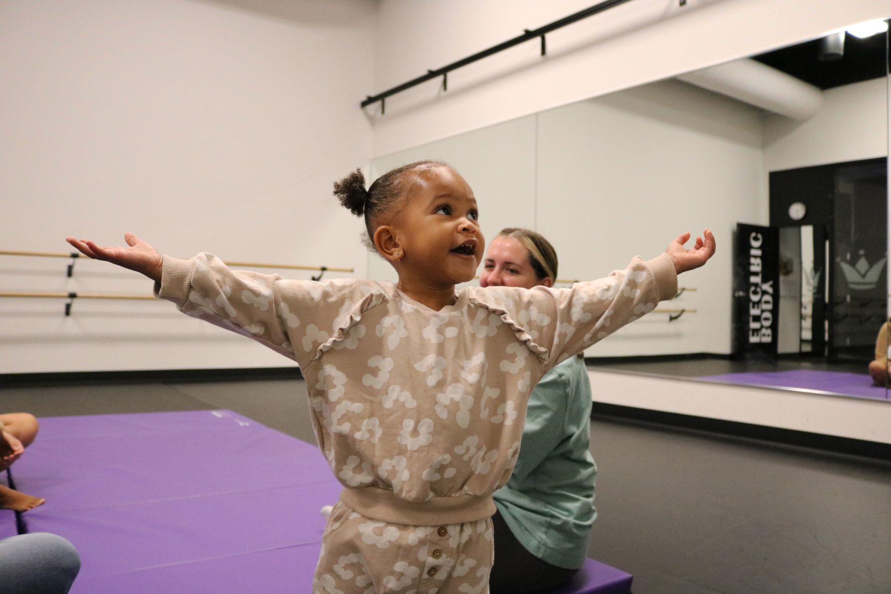 Little girl smiling with arms out