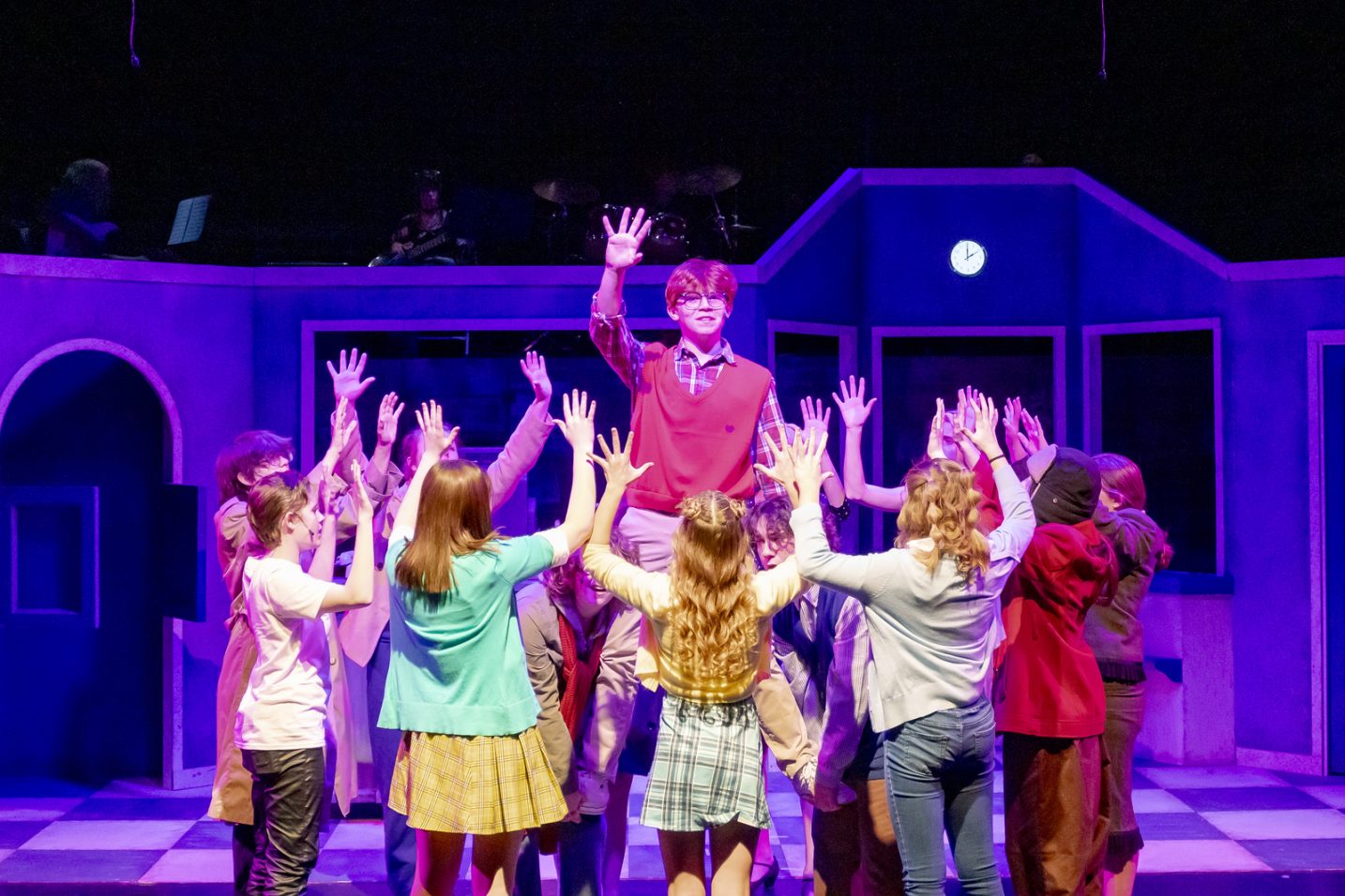Teenagers dancing and singing on stage